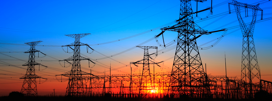 View of several rows of power lines at sunset